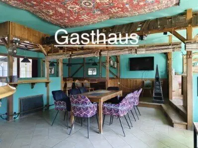 Guesthouse Café Pizzeria with an accompanying modern residential house