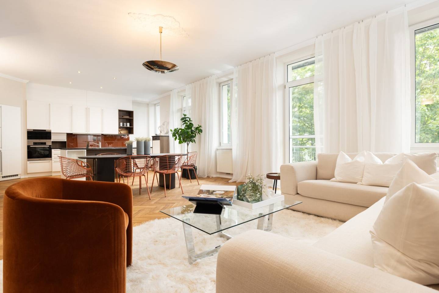 Timeless historic apartment elegance with open fireplace, custom built-ins and balcony overlooking greenery
