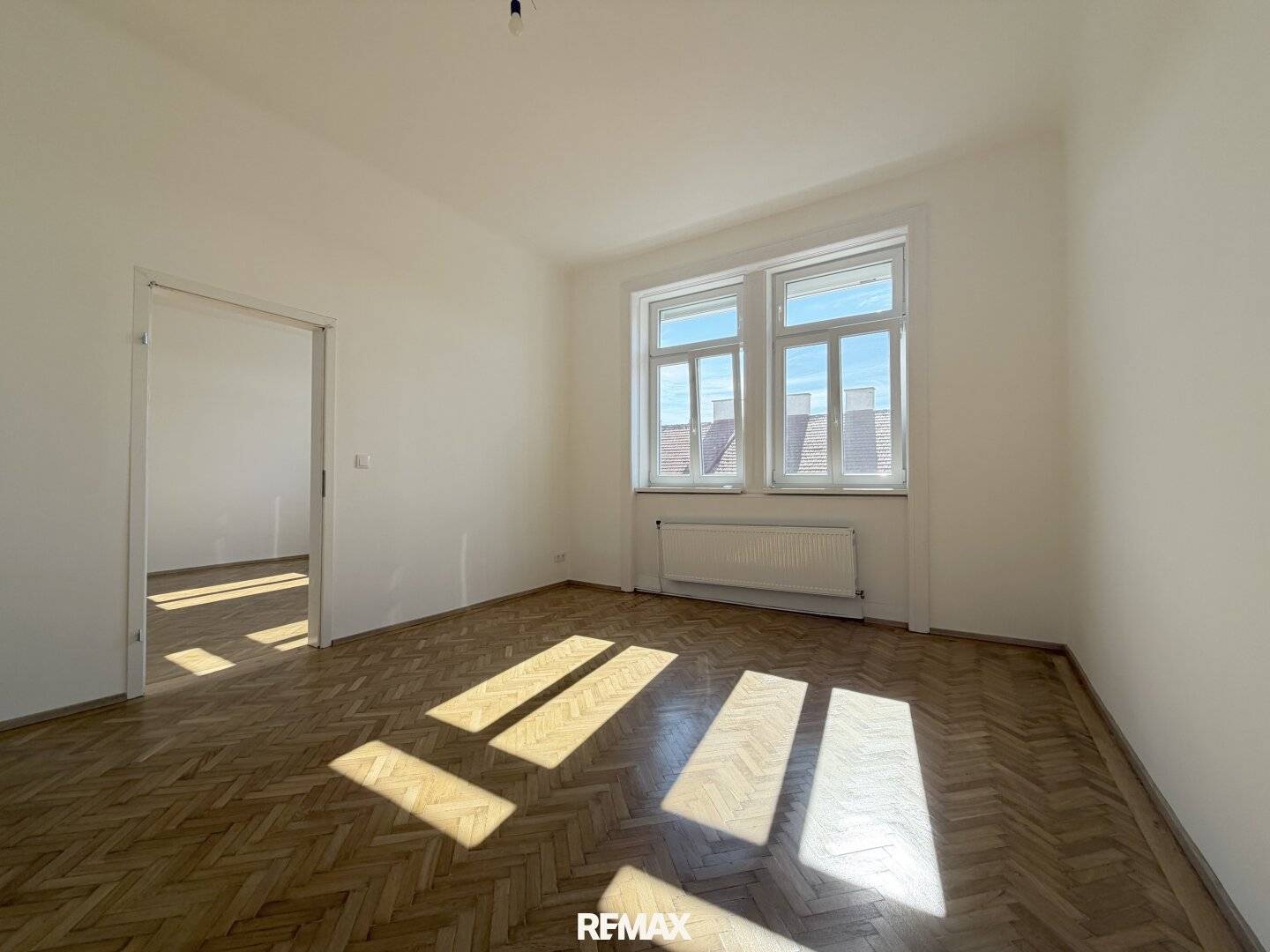 Bright period apartment with tiled stove and herringbone parquet