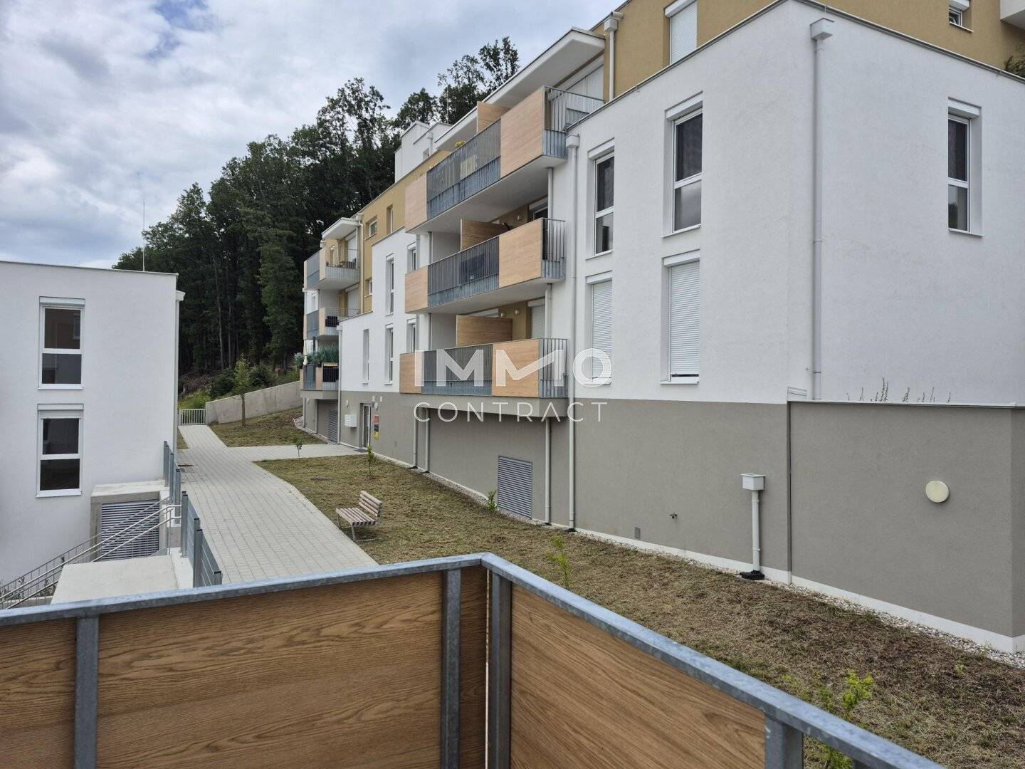 Modern new build apartment with balcony surrounded by greenery