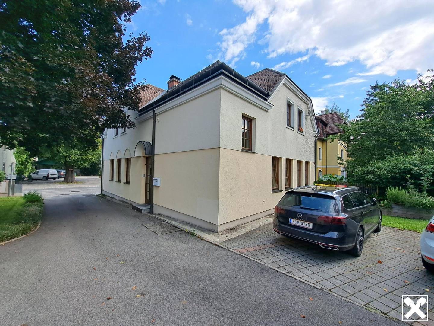 Former bank branch with rented apartment and garden