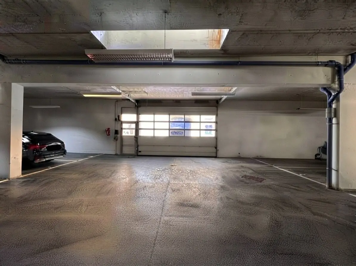 Bright parking space in private garage with daylight