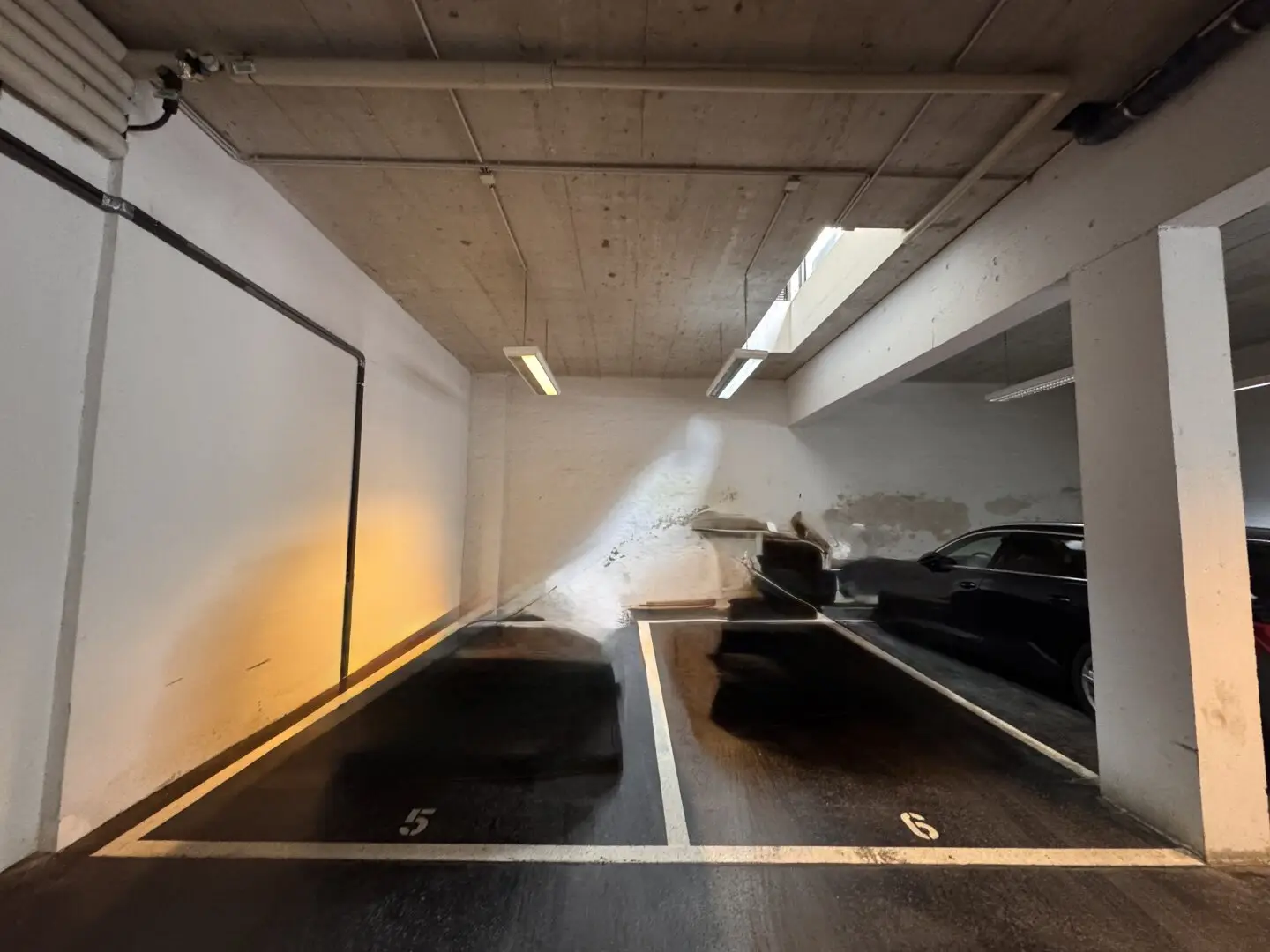 Bright parking space in private garage with daylight