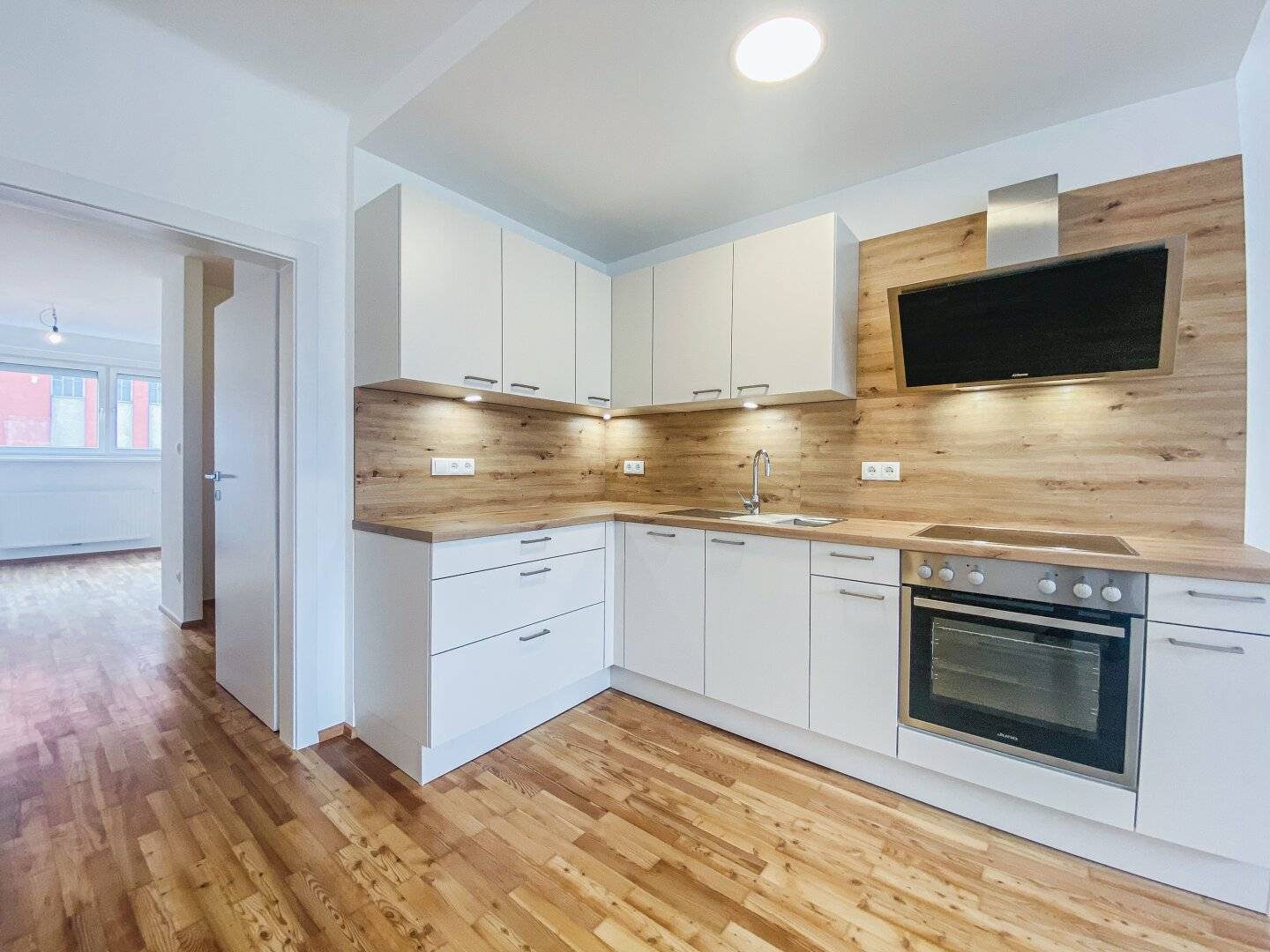 Renovated apartment with open living area and distant view