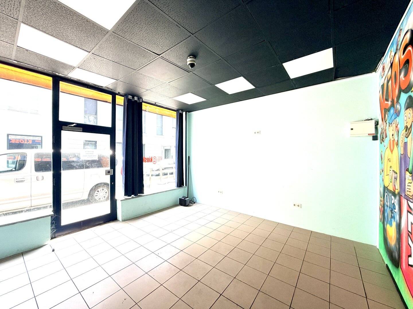 Small commercial space with large storefront windows in a good location