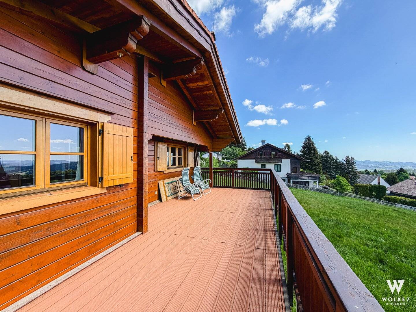 Modern wooden house with balcony and distant view
