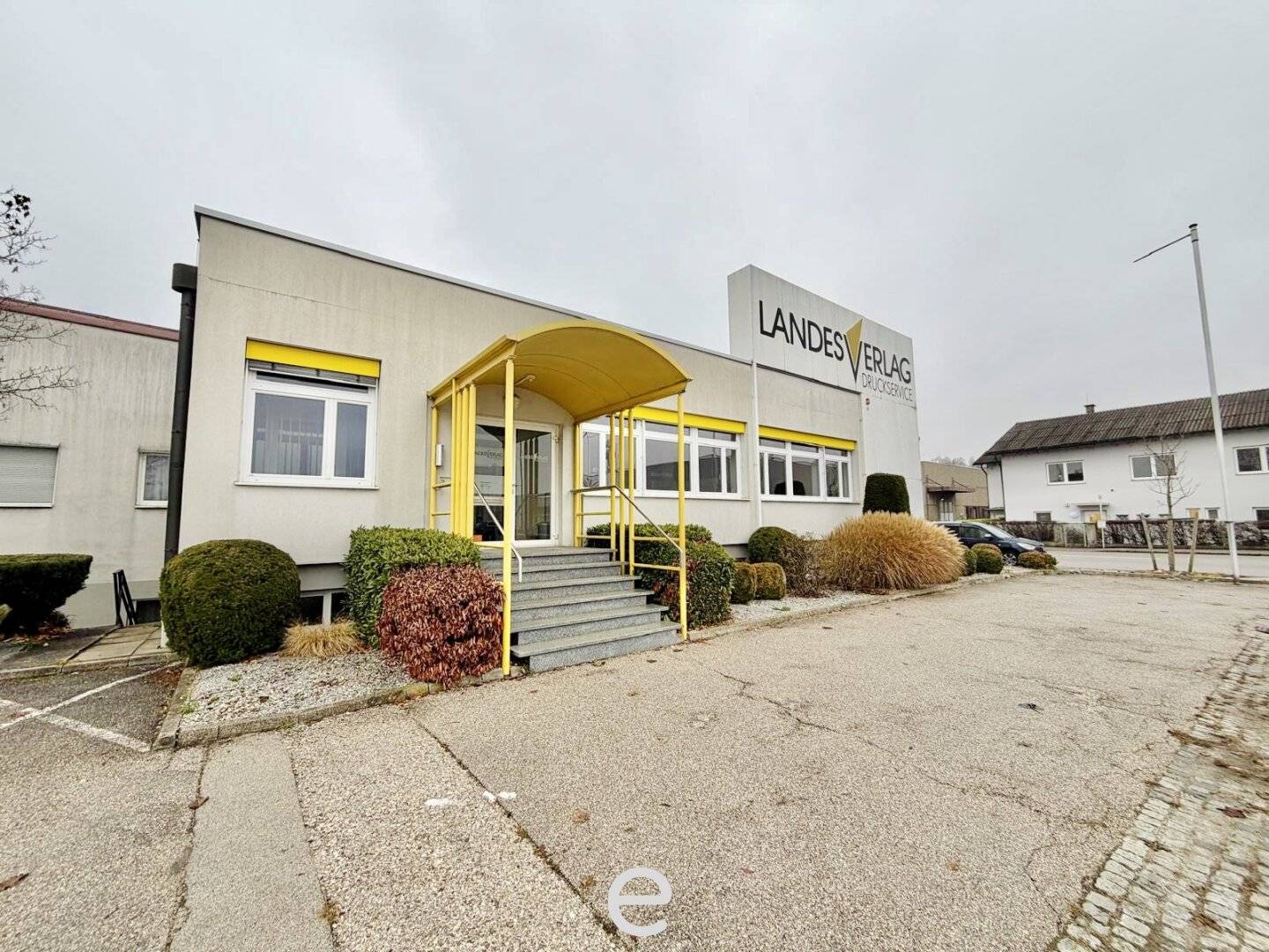 Warehouse with loading ramps and modern office space in industrial area