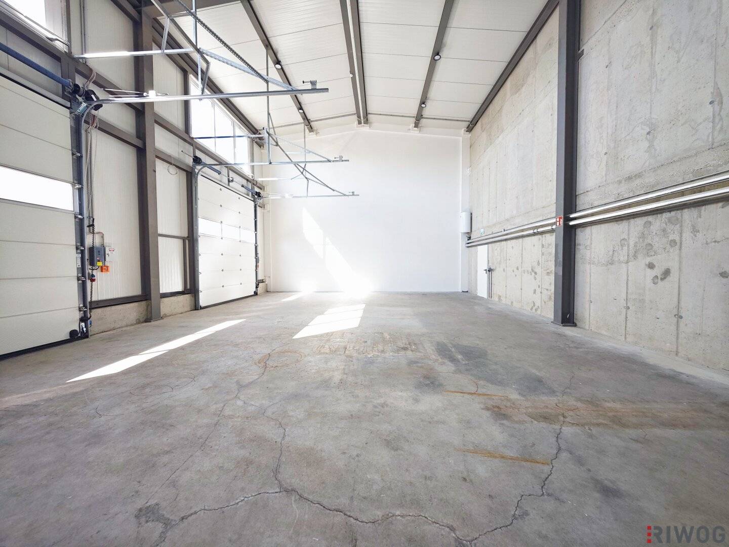 Production space with office or showroom spaces | ground-level access through three sectional doors | parking spaces &amp; air source heat pump