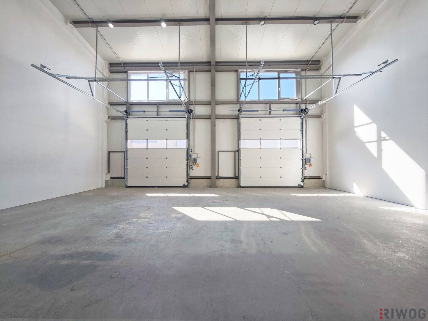 Production space with office or showroom spaces | ground-level access through three sectional doors | parking spaces &amp; air source heat pump