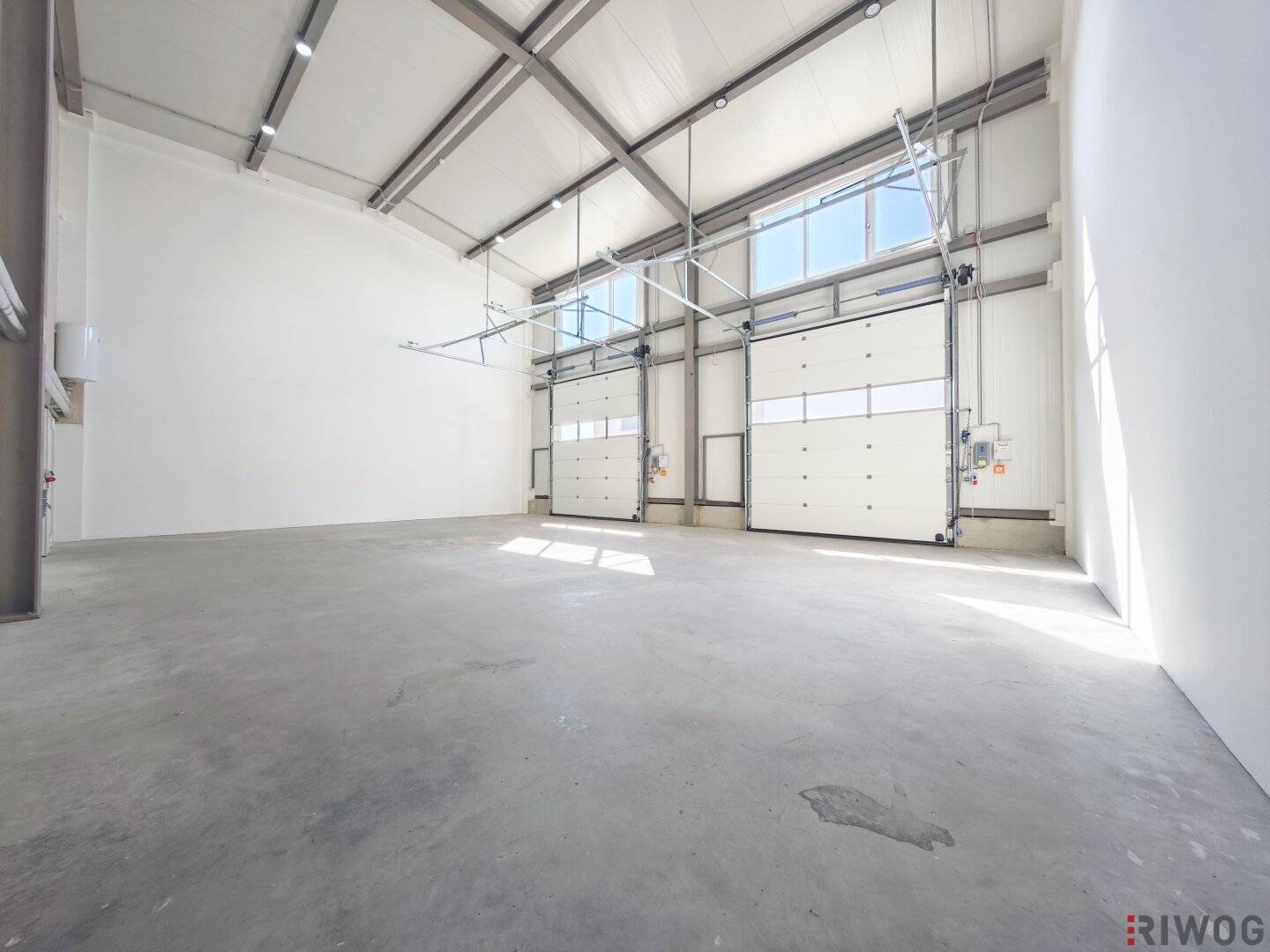 Production space with office or showroom spaces | ground-level access through three sectional doors | parking spaces &amp; air source heat pump