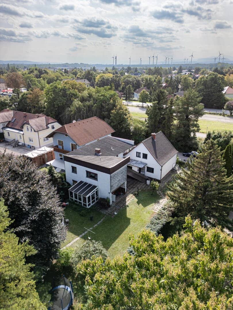 Large plot with two houses in need of renovation and garage on large grounds