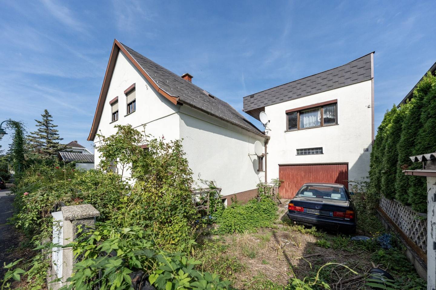 Large plot with two houses in need of renovation and garage on large grounds