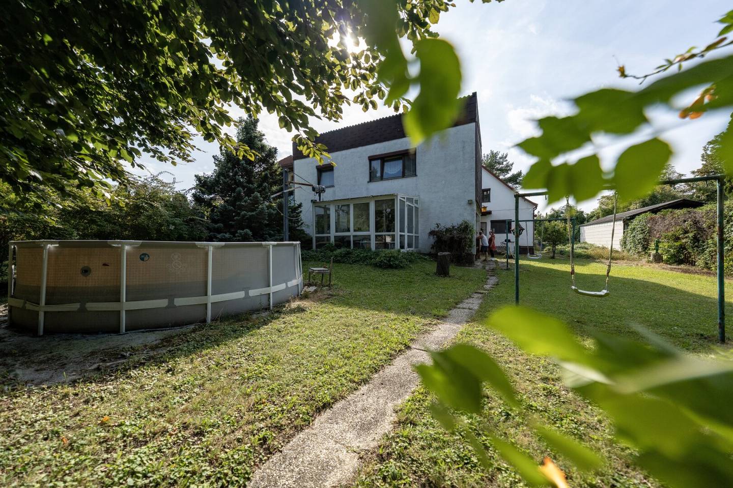 Large plot with two houses in need of renovation and garage on large grounds