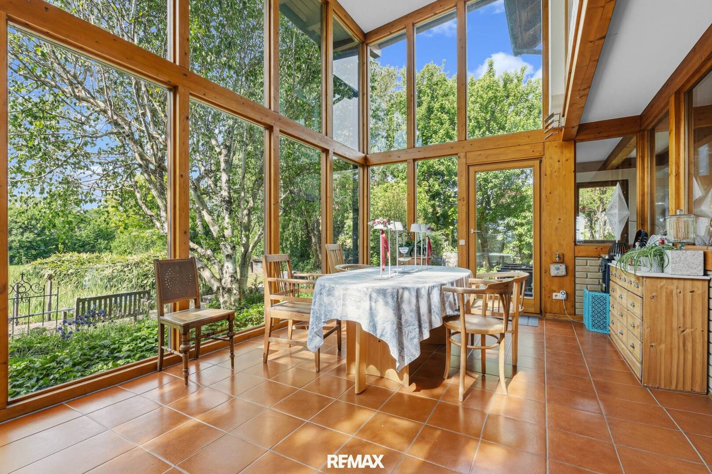 Light-filled single-family house in country house style with natural pool in a garden paradise