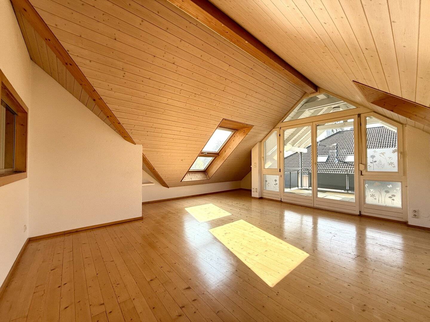 Spacious attic ambiance with Swedish stove and bright living character