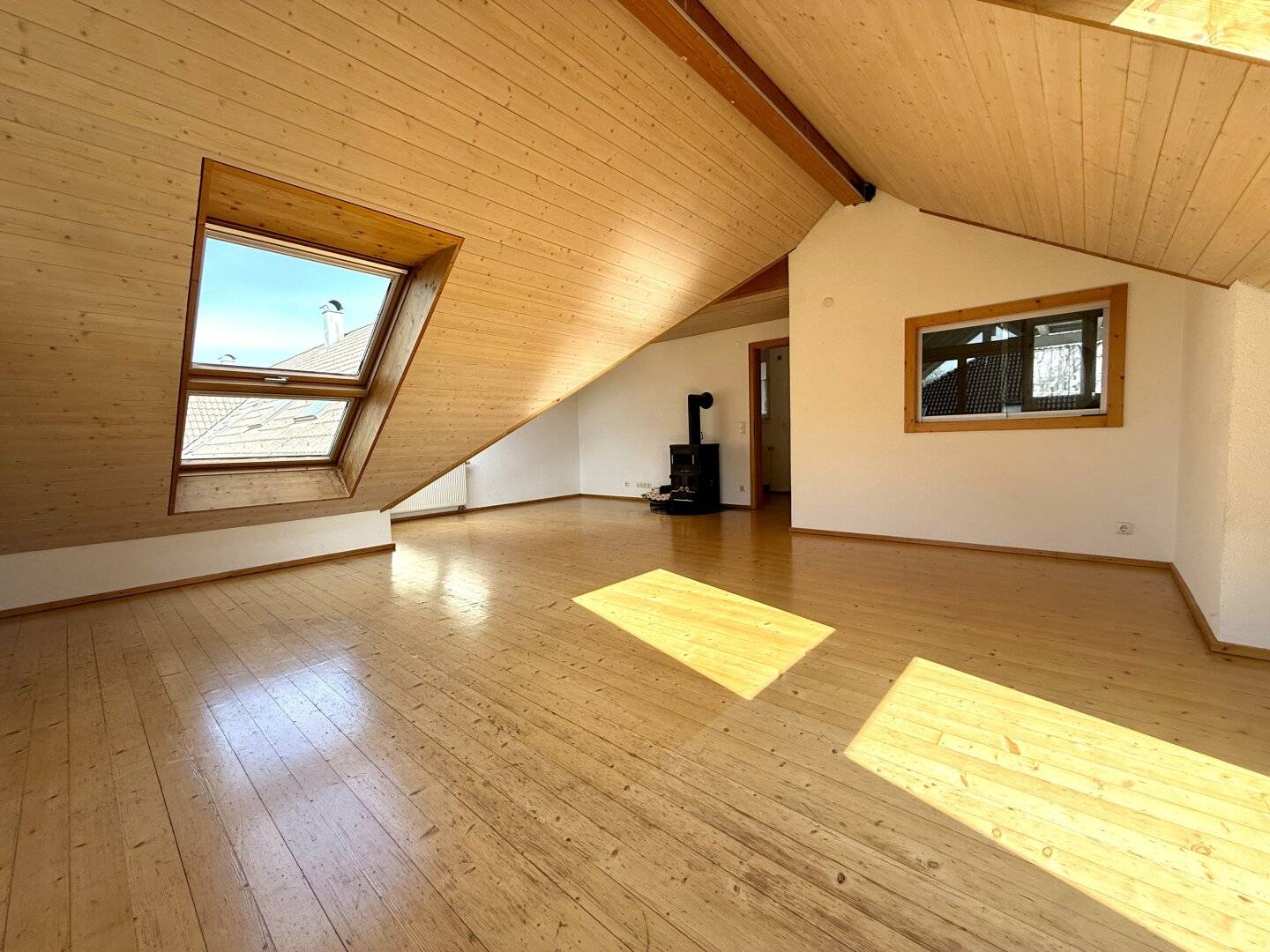 Spacious attic ambiance with Swedish stove and bright living character