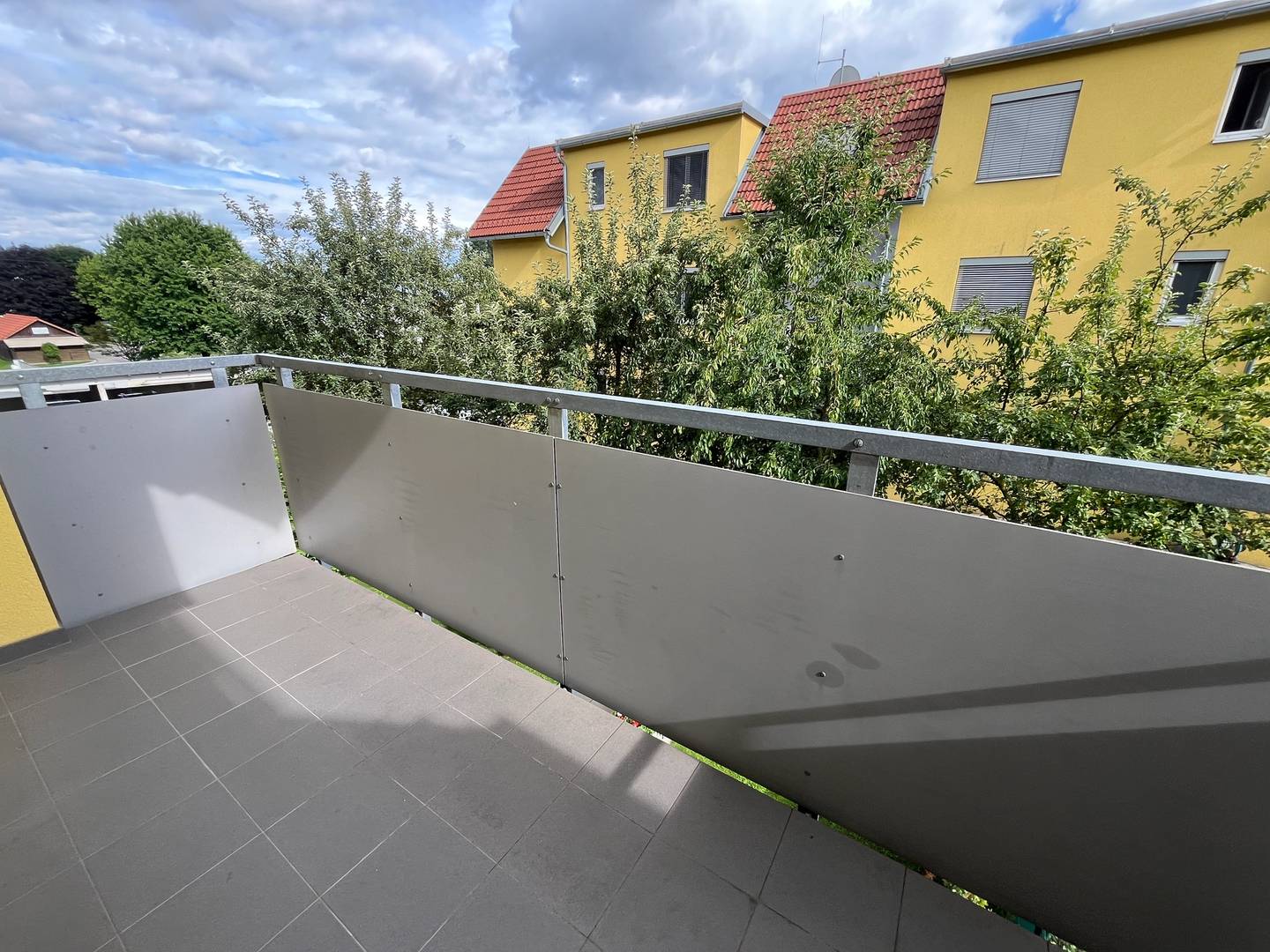 Bright apartment with covered balcony and carport