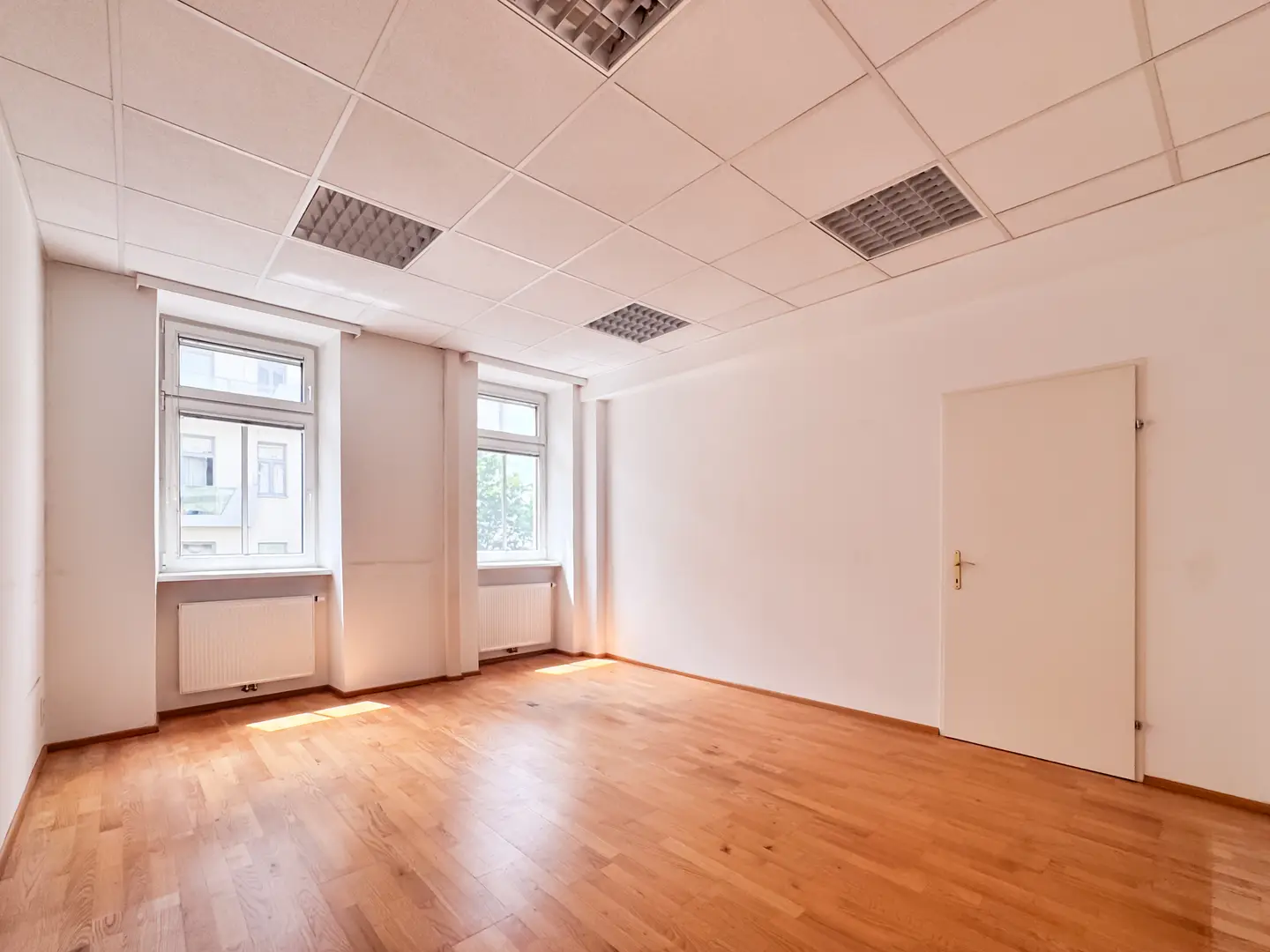Bright office with parquet and a practical layout