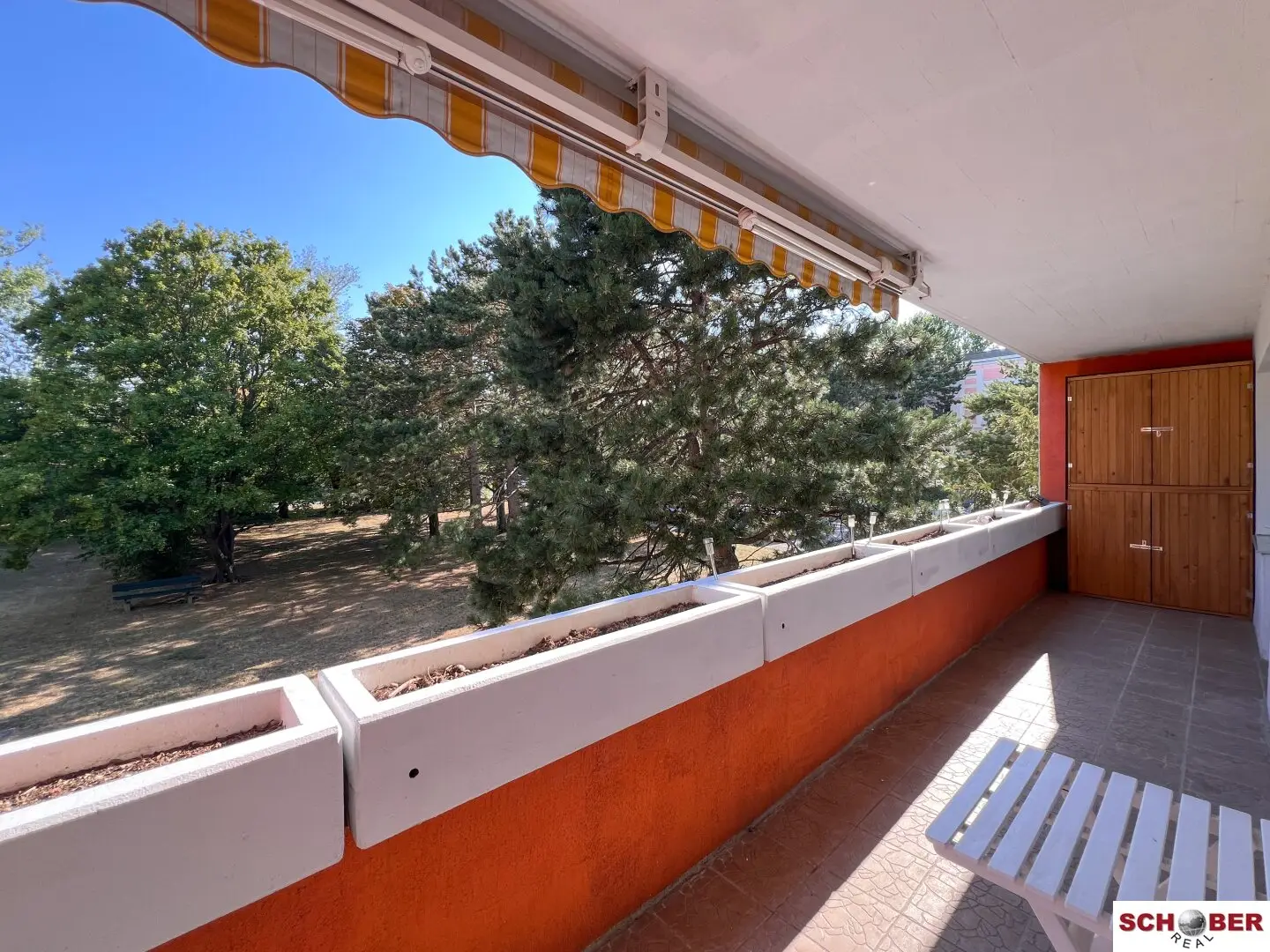 Sunny south-facing loggia, spacious living with view of greenery