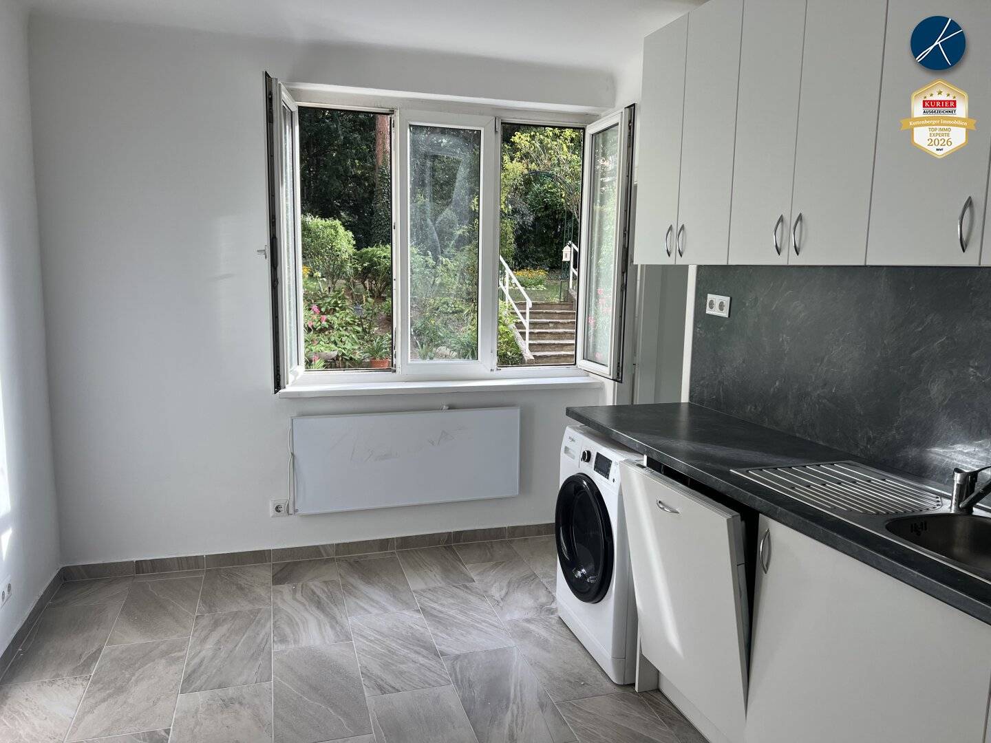 Open-plan kitchen with garden view plus room