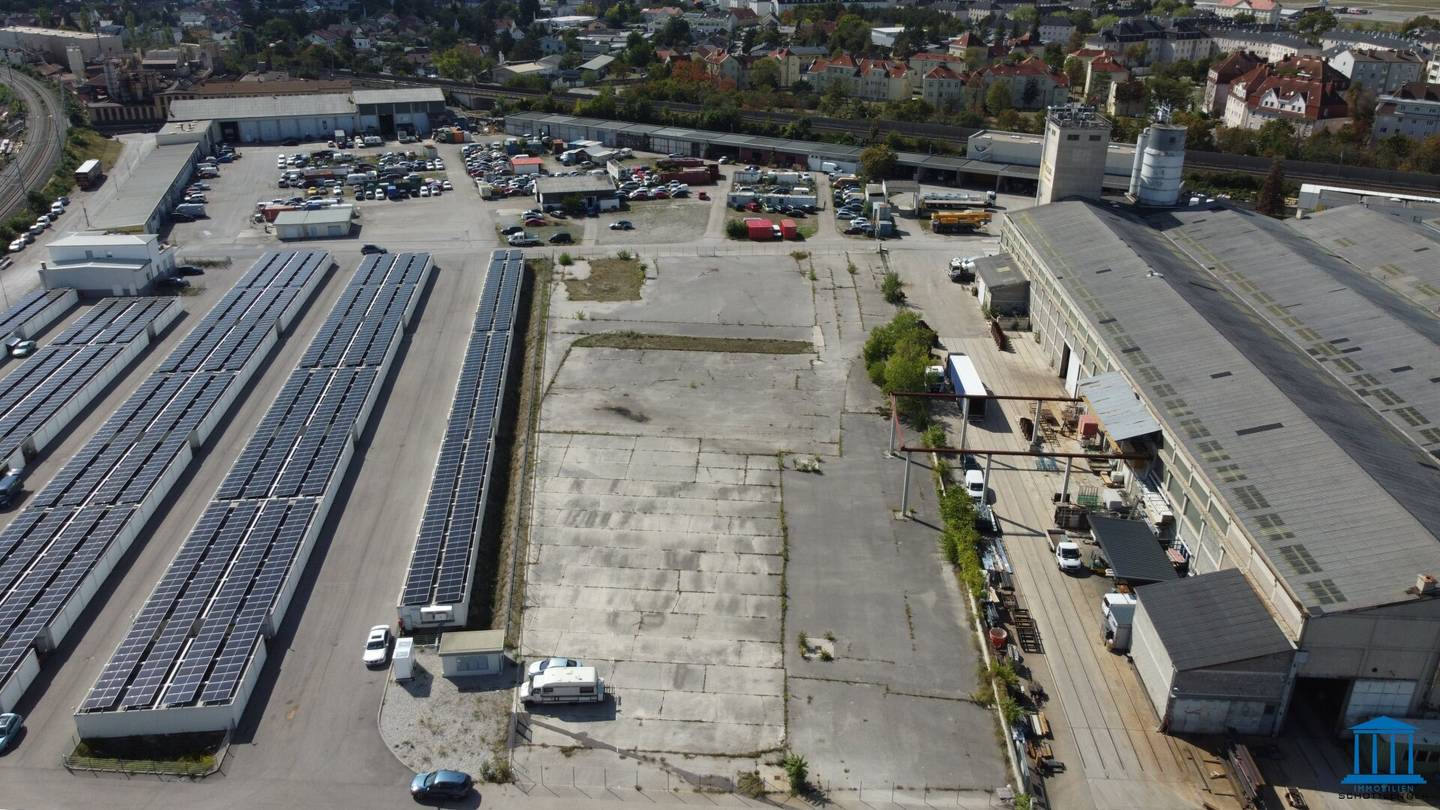 Paved, fenced open area optionally with building right or superstructure