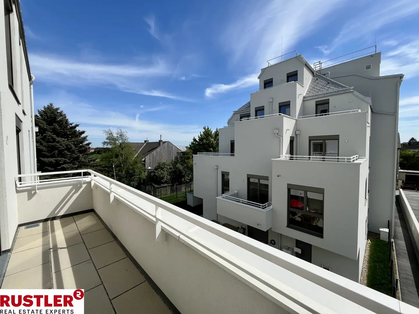 Modern apartment with photovoltaic system and green surroundings