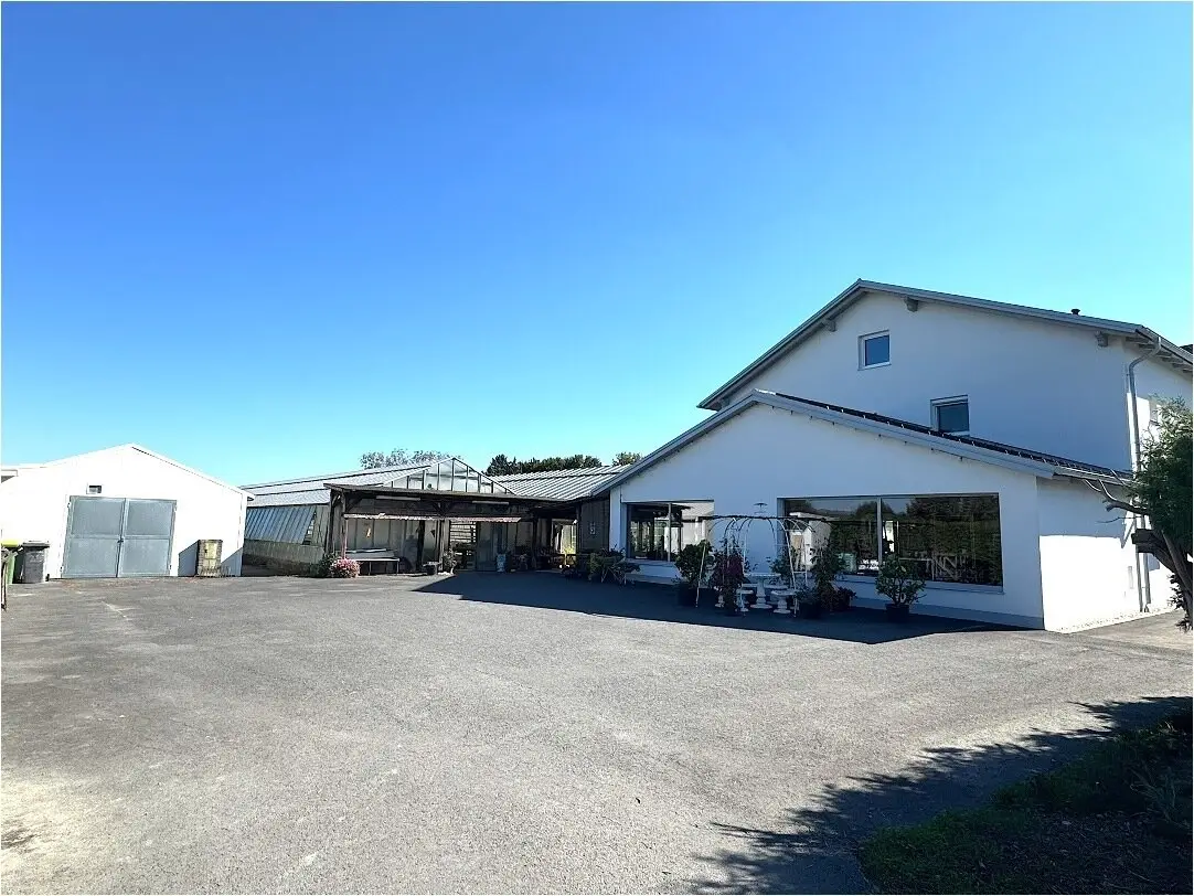 Premium listing – Multi-family house with former nursery & approx. 1 ha land in Burgau